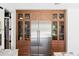 Kitchen featuring a stainless steel refrigerator and wooden cabinets with glass doors at 916 Kincade Dr, Mount Pleasant, SC 29464