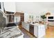 Open-concept kitchen and living area with wood flooring and natural light at 916 Kincade Dr, Mount Pleasant, SC 29464