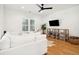 Bright living room with white sectional sofa, hardwood floors, and modern ceiling fan at 916 Kincade Dr, Mount Pleasant, SC 29464