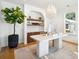 Bright home office with built-in shelving, chandelier, and a modern desk at 916 Kincade Dr, Mount Pleasant, SC 29464
