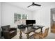 Bright office space featuring a wooden desk, dual monitors, and a comfortable reading chair near a sunlit window at 916 Kincade Dr, Mount Pleasant, SC 29464