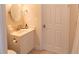 Bright bathroom featuring a modern vanity with a round mirror and a white paneled door at 10 Toms Turnaround Cir, Edisto Island, SC 29438