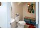 This bathroom features a round mirror, pedestal sink, and toilet at 10 Toms Turnaround Cir, Edisto Island, SC 29438