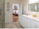 Bathroom with dual sinks, stone countertop and tile floors that opens to the bedroom at 10 Toms Turnaround Cir, Edisto Island, SC 29438