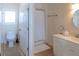Well-lit bathroom with tub-shower, toilet, and a white vanity with a square framed window at 10 Toms Turnaround Cir, Edisto Island, SC 29438