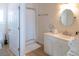 Bright bathroom with a shower-tub, white vanity, and warm lighting creating an inviting space at 10 Toms Turnaround Cir, Edisto Island, SC 29438