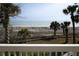 Balcony view of the beach with palm trees and a sand dune at 10 Toms Turnaround Cir, Edisto Island, SC 29438