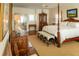 Well-lit bedroom with a four-poster bed, wooden furniture, and a comfortable bench at 10 Toms Turnaround Cir, Edisto Island, SC 29438