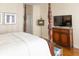 Bedroom featuring a four-poster bed and a TV cabinet with detailed wood craftsmanship at 10 Toms Turnaround Cir, Edisto Island, SC 29438