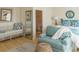 Bright bedroom with hardwood floors, a seating area, and blue accents offers a welcoming and stylish retreat at 10 Toms Turnaround Cir, Edisto Island, SC 29438