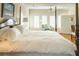 Bright bedroom with a four-poster bed, plush bedding, and a comfortable reading nook at 10 Toms Turnaround Cir, Edisto Island, SC 29438