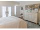Bright bedroom with French doors, a dresser, and stylish furnishings, creating a comfortable and inviting atmosphere at 10 Toms Turnaround Cir, Edisto Island, SC 29438