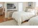 Bedroom featuring two beds, a wooden dresser with TV, and comfortable seating offering a cozy retreat at 10 Toms Turnaround Cir, Edisto Island, SC 29438