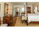 Spacious bedroom with a four-poster bed, hardwood floors, and plenty of natural light at 10 Toms Turnaround Cir, Edisto Island, SC 29438