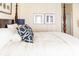 Bright bedroom featuring a four-poster bed, soft lighting, and coastal artwork at 10 Toms Turnaround Cir, Edisto Island, SC 29438