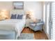 Cozy bedroom with a bed, chair, bedside tables, and bright natural light from nearby windows at 10 Toms Turnaround Cir, Edisto Island, SC 29438