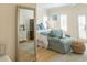 Inviting bedroom features neutral colors, comfortable seating, French doors, and natural light from multiple windows with shutters at 10 Toms Turnaround Cir, Edisto Island, SC 29438