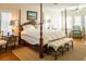 Spacious bedroom featuring a four-poster bed, neutral walls, and hardwood floors at 10 Toms Turnaround Cir, Edisto Island, SC 29438