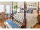 Serene bedroom showcases a four-poster bed, a cozy seating area, and natural light from the windows at 10 Toms Turnaround Cir, Edisto Island, SC 29438