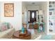 View of the home's entryway, featuring a stylish front door and an inviting living space with coastal decor at 10 Toms Turnaround Cir, Edisto Island, SC 29438