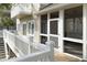Rear exterior view shows elevated screened porch with stairs and white railing at 10 Toms Turnaround Cir, Edisto Island, SC 29438