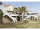 Picturesque coastal home with dual balconies, showcasing the beauty of elevated living at 10 Toms Turnaround Cir, Edisto Island, SC 29438