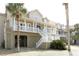 Stunning coastal home featuring elevated construction, a large porch, and ample outdoor space at 10 Toms Turnaround Cir, Edisto Island, SC 29438