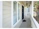 Charming front porch featuring columns, neutral siding, and inviting entry at 10 Toms Turnaround Cir, Edisto Island, SC 29438