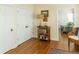 Bright hallway featuring hardwood floors, a charming bookshelf, and a glimpse into the living room at 10 Toms Turnaround Cir, Edisto Island, SC 29438