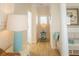 Bright hallway with neutral walls, hardwood floors, and blue accents offers a clean and welcoming transition space at 10 Toms Turnaround Cir, Edisto Island, SC 29438
