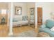 Bright hallway with hardwood floors, a seating area, and blue accents offers a welcoming and stylish retreat at 10 Toms Turnaround Cir, Edisto Island, SC 29438
