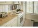 Bright kitchen with oven and a view to the home's entrance at 10 Toms Turnaround Cir, Edisto Island, SC 29438