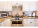 Kitchen features stainless steel gas range, granite countertops, and white cabinets at 10 Toms Turnaround Cir, Edisto Island, SC 29438