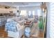 Bright, airy living room with cozy seating, access to the kitchen, and sliding doors to an outdoor space at 10 Toms Turnaround Cir, Edisto Island, SC 29438