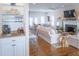 Bright living room features hardwood floors, fireplace, white sofas, and an entertainment area at 10 Toms Turnaround Cir, Edisto Island, SC 29438