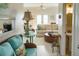 Bright living room featuring wicker furniture, neutral sofa, and a bathroom in view at 10 Toms Turnaround Cir, Edisto Island, SC 29438
