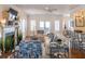 Bright living room featuring hardwood floors, fireplace, comfortable seating, and lots of natural light at 10 Toms Turnaround Cir, Edisto Island, SC 29438