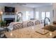 Inviting living room with a fireplace, comfortable seating, and a view into the kitchen and dining areas at 10 Toms Turnaround Cir, Edisto Island, SC 29438