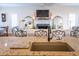 Granite kitchen sink overlooks the fireplace and sofas in the living room at 10 Toms Turnaround Cir, Edisto Island, SC 29438