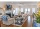 Bright living room featuring hardwood floors, fireplace, and comfortable seating at 10 Toms Turnaround Cir, Edisto Island, SC 29438
