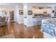 Open living space features hardwood floors, seamless transition to a modern kitchen, and a laundry room entrance at 10 Toms Turnaround Cir, Edisto Island, SC 29438