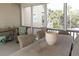 Screened porch featuring a rustic wooden table, wicker chairs and scenic views of a lush landscape at 10 Toms Turnaround Cir, Edisto Island, SC 29438