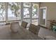 Beachfront porch with palm tree views, wicker chairs and table to create a seaside paradise at 10 Toms Turnaround Cir, Edisto Island, SC 29438