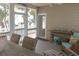 Charming porch with open views leading to a sunny beach with palm trees in the distance at 10 Toms Turnaround Cir, Edisto Island, SC 29438