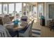 Inviting screened porch features wicker furniture, outdoor dining area, and serene ocean views at 10 Toms Turnaround Cir, Edisto Island, SC 29438