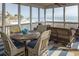 Inviting screened porch features wicker furniture, outdoor dining area, and ocean views at 10 Toms Turnaround Cir, Edisto Island, SC 29438