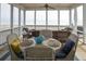 The screened porch offers a beautiful view of the beach and has plenty of seating at 10 Toms Turnaround Cir, Edisto Island, SC 29438