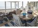 Beautiful screened-in porch with wicker furniture, ocean view, and beachy decor at 10 Toms Turnaround Cir, Edisto Island, SC 29438