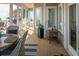 Comfortable screened porch with wicker furniture, ocean views, and wood flooring at 10 Toms Turnaround Cir, Edisto Island, SC 29438