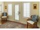 Cozy sitting area with natural light, shuttered windows, chairs and a colorful area rug at 10 Toms Turnaround Cir, Edisto Island, SC 29438